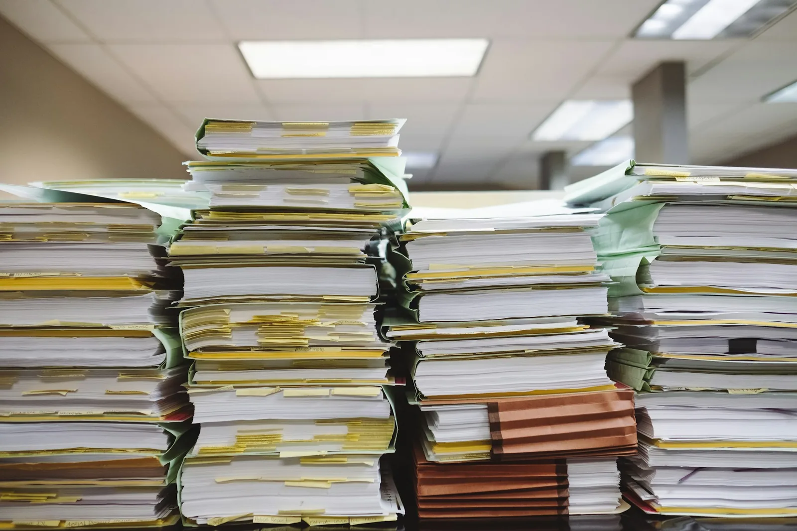 A folder of paperwork and records open on a table