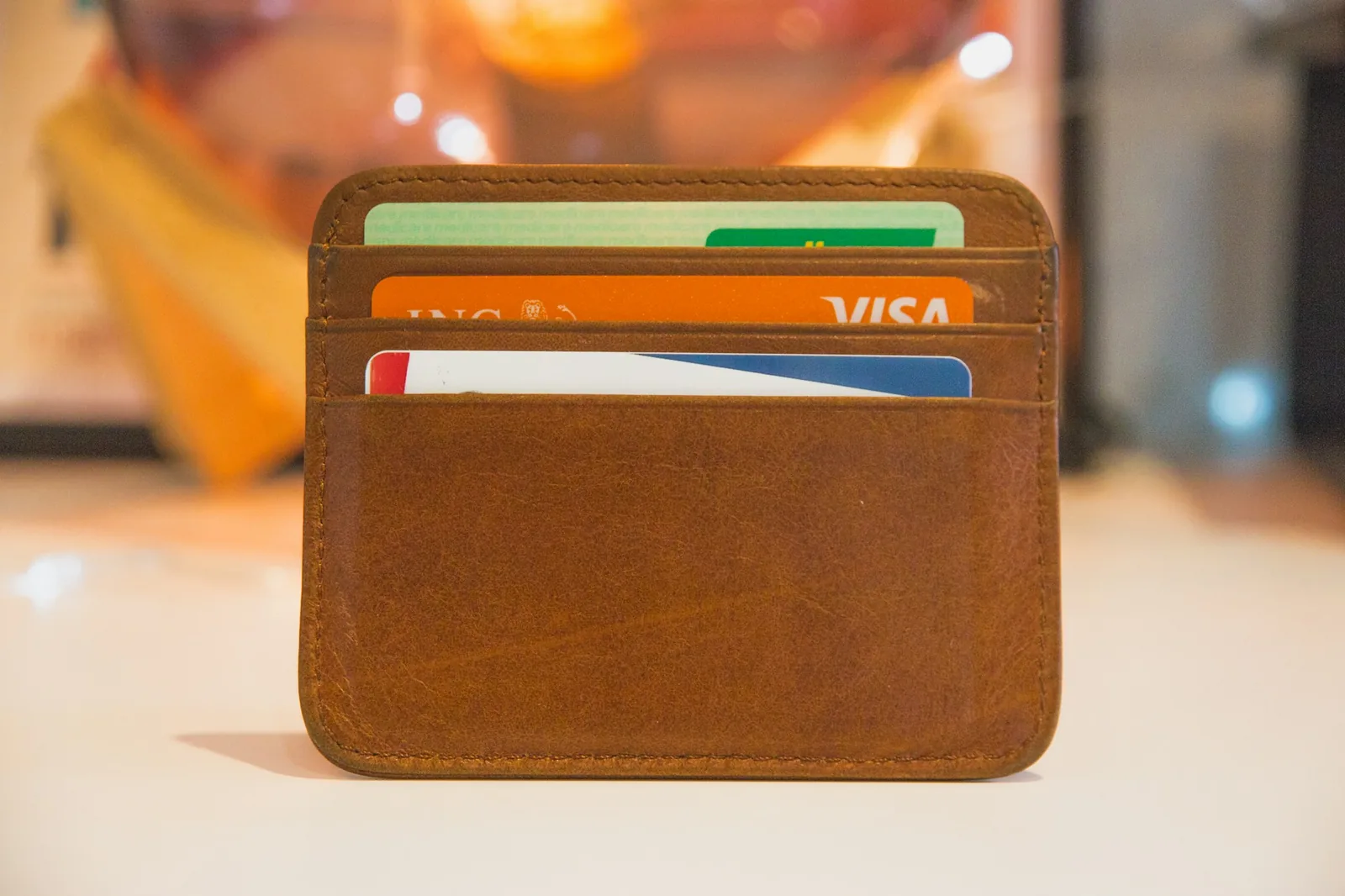 A wallet open on a table showing cards inside