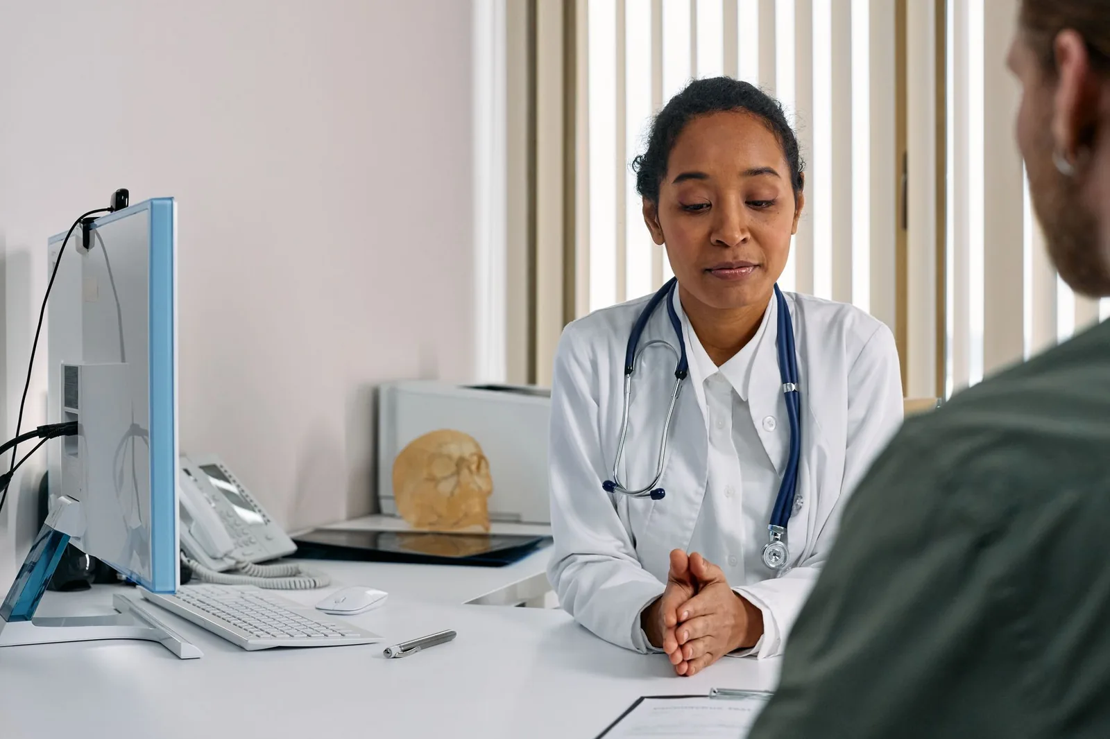 A doctor talking with a patient in a consulting room