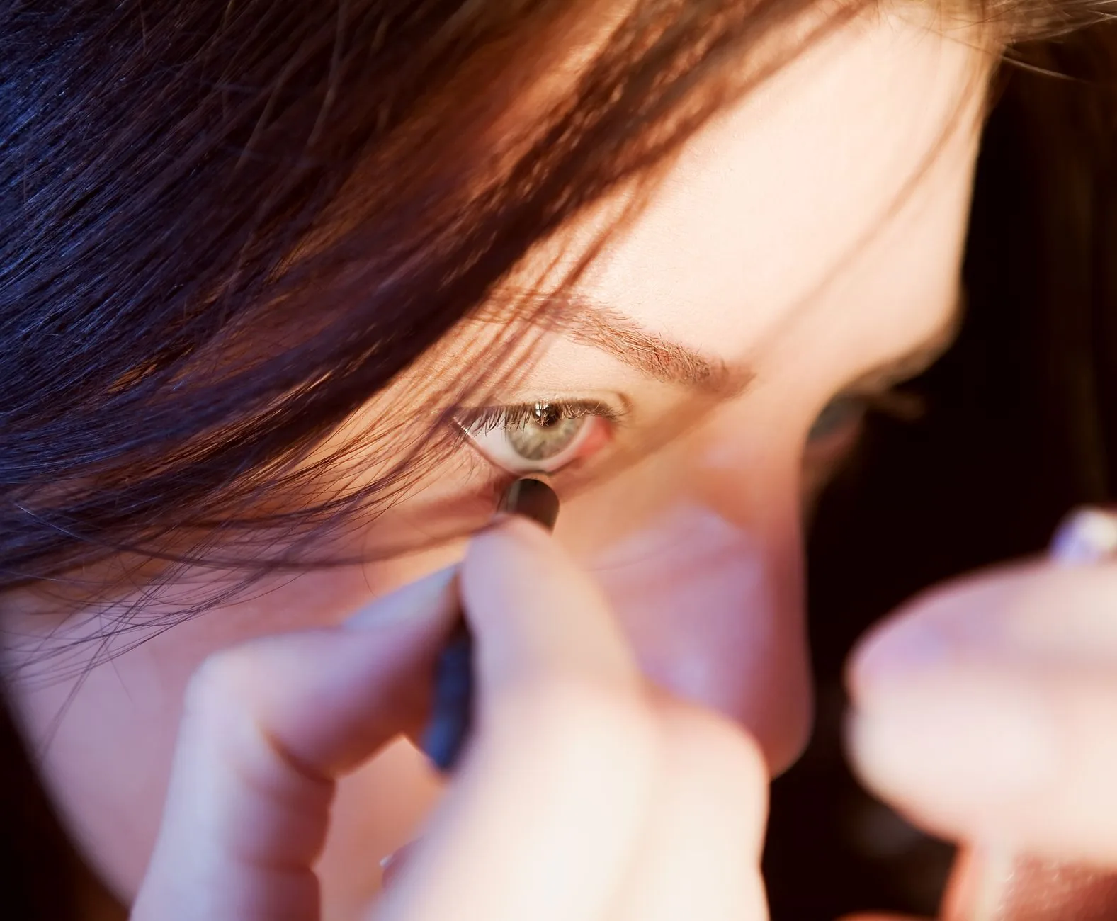 Eye drops being applied to a small dog