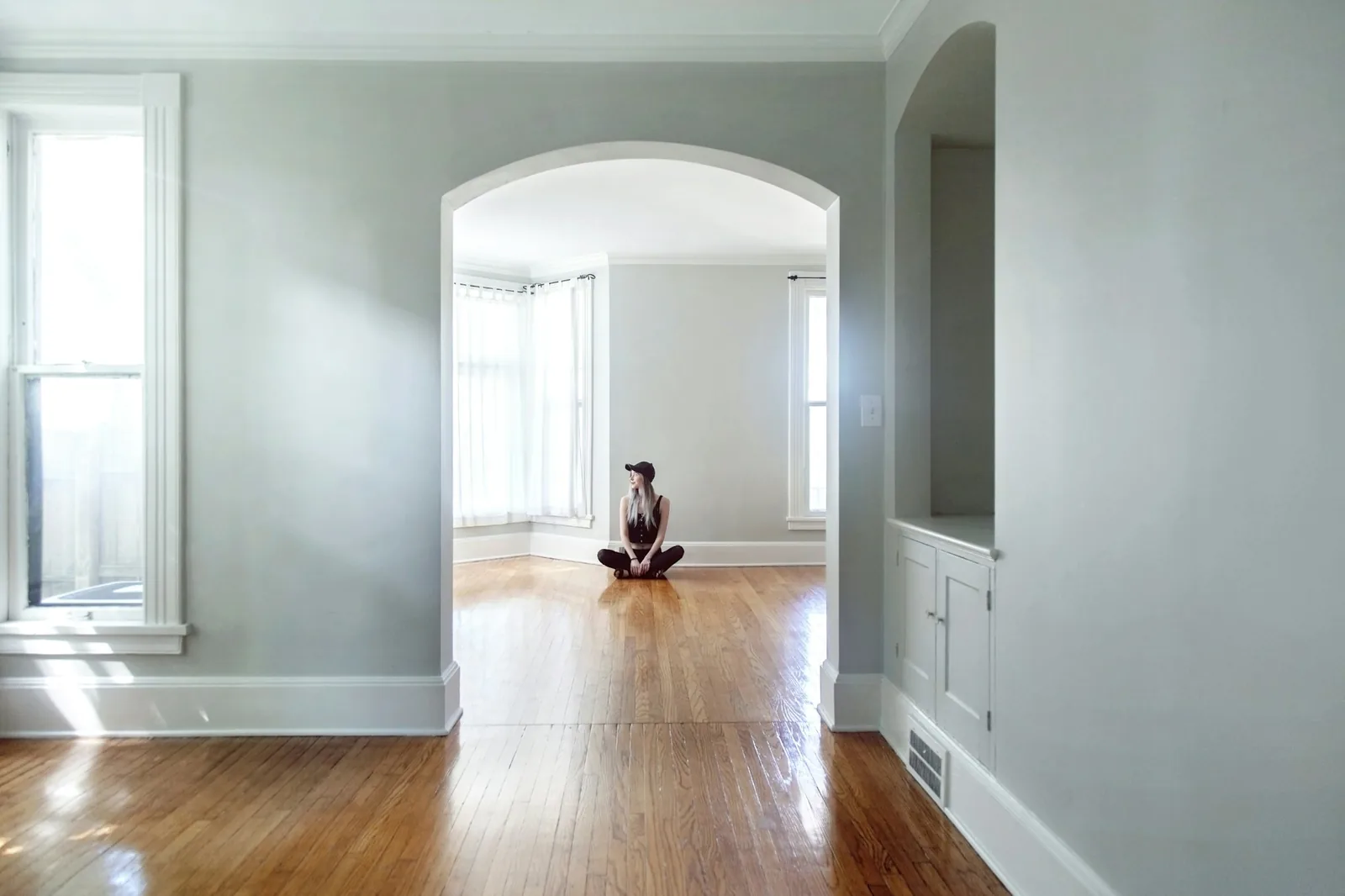 A dog lying alone in a quiet empty room