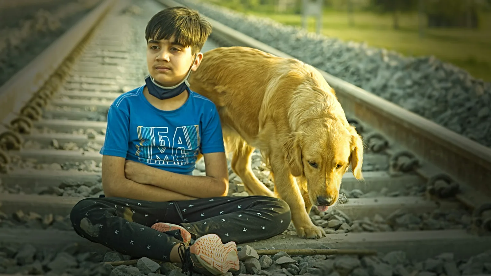 A child sitting quietly on the floor near a dog