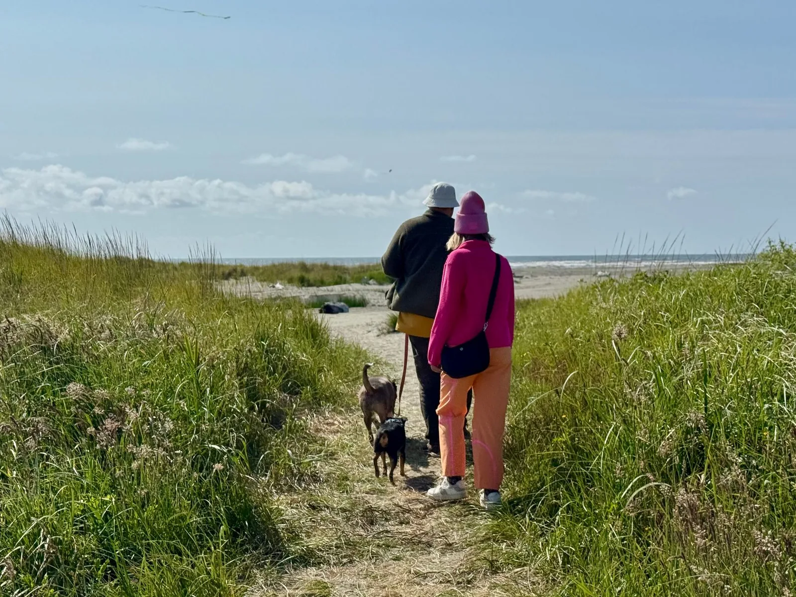 Two people outdoors with a small dog