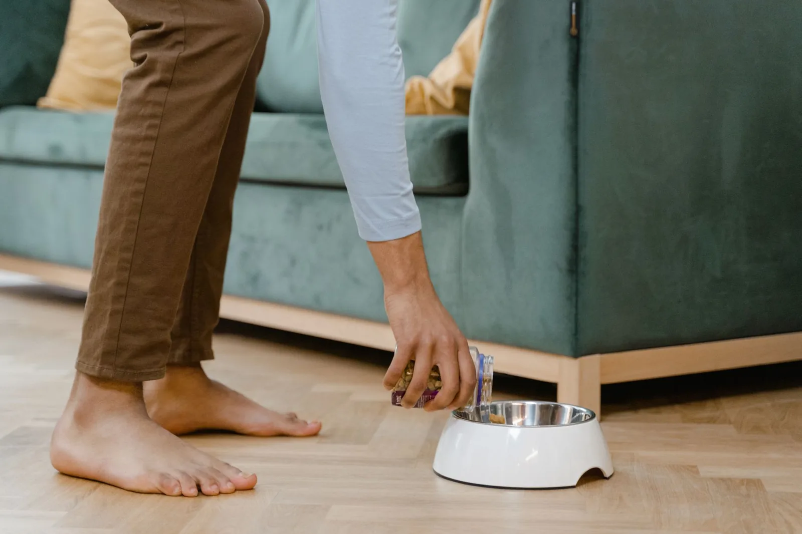 An empty water bowl on a kitchen floor