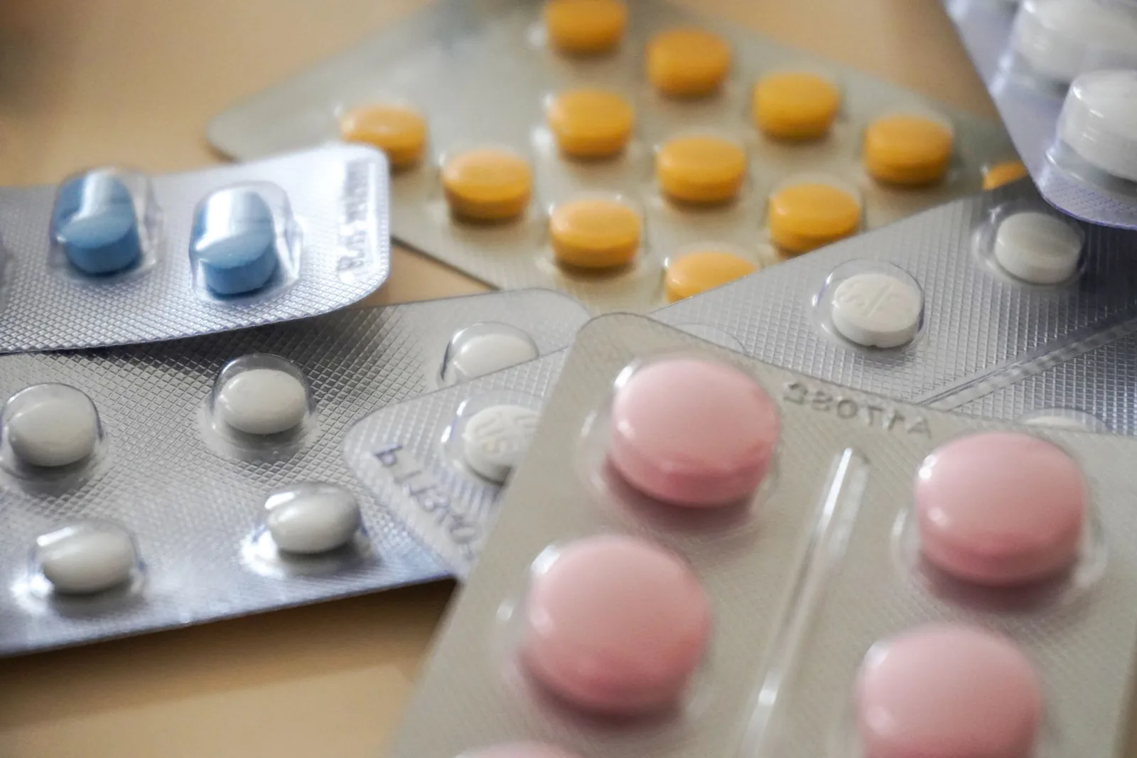 Loose tablets and a medicine bottle on a counter