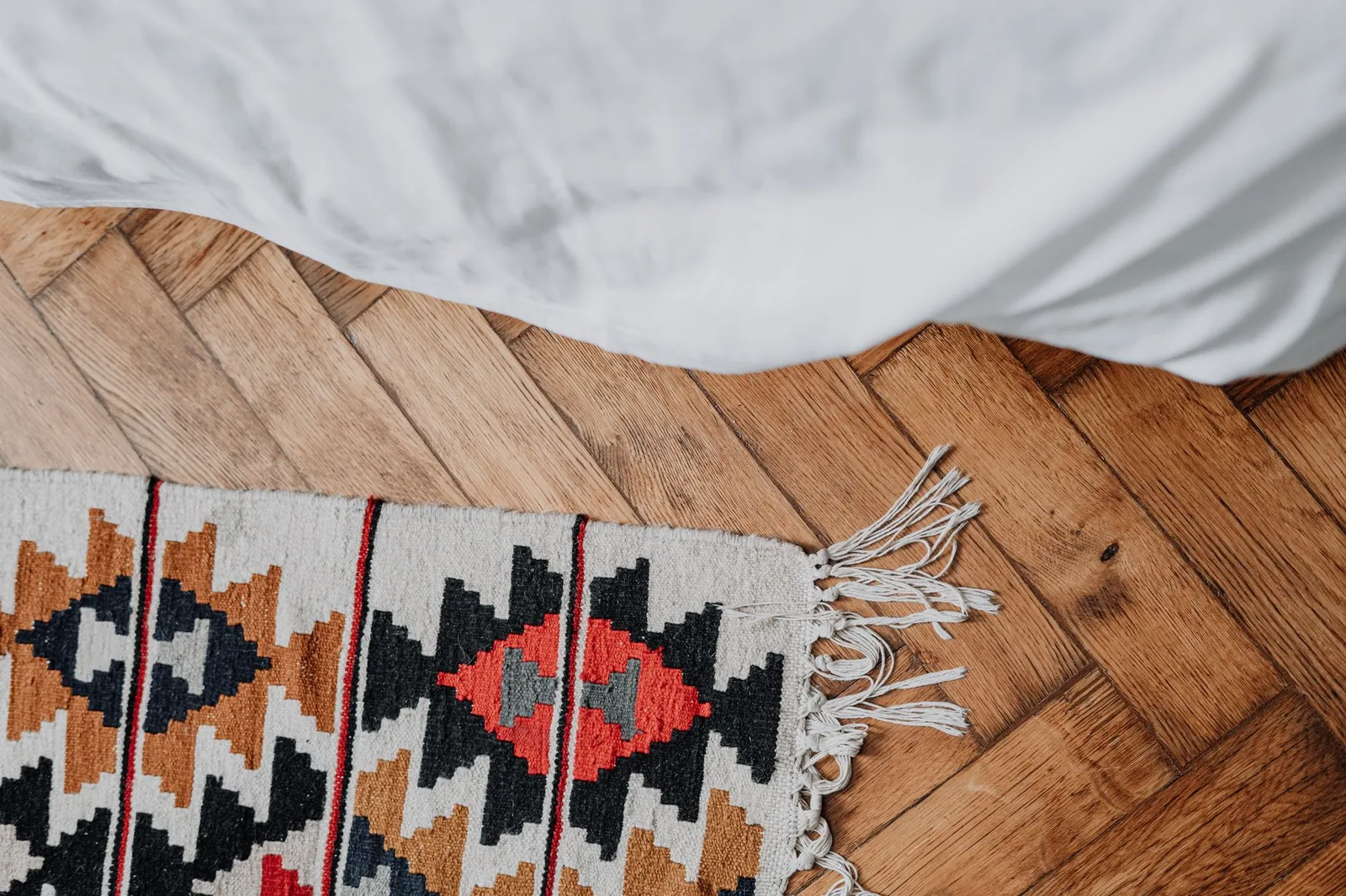A rug runner laid across a wooden floor