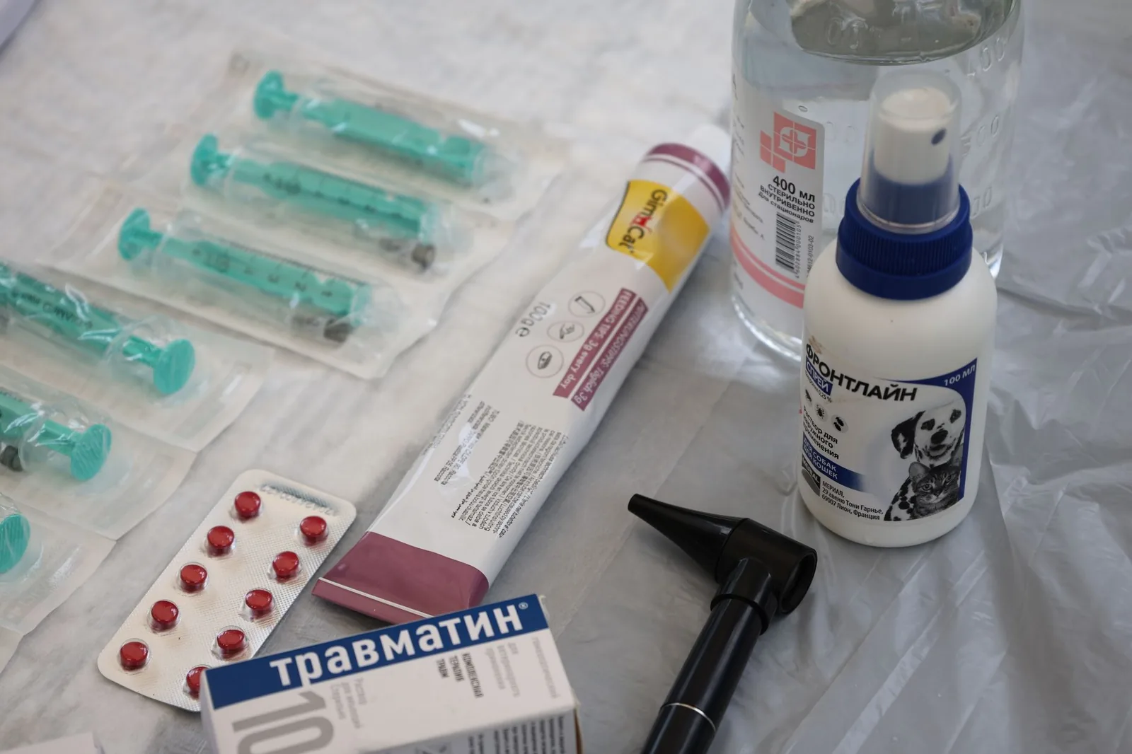 A syringe and medical supplies laid out on a surface