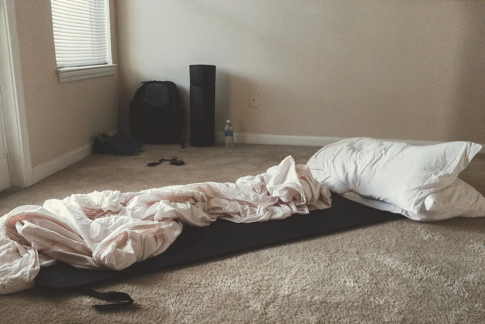 A dog bed tucked into a quiet corner away from the door