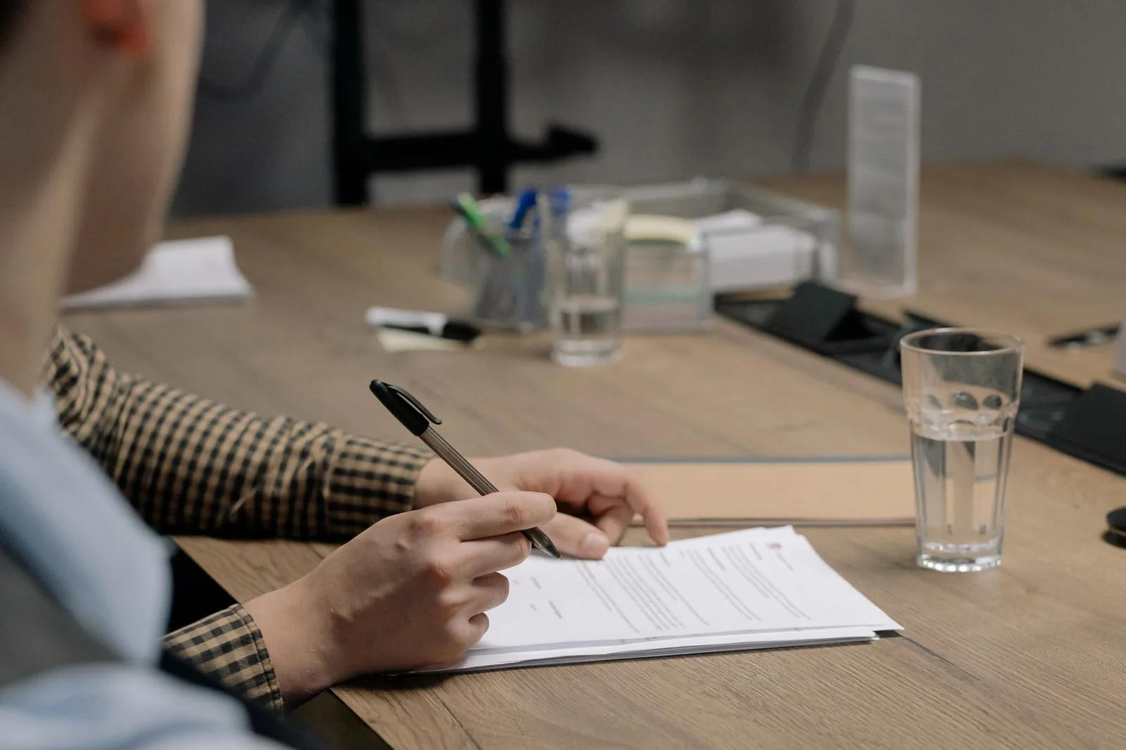A person reading a lease agreement at a table