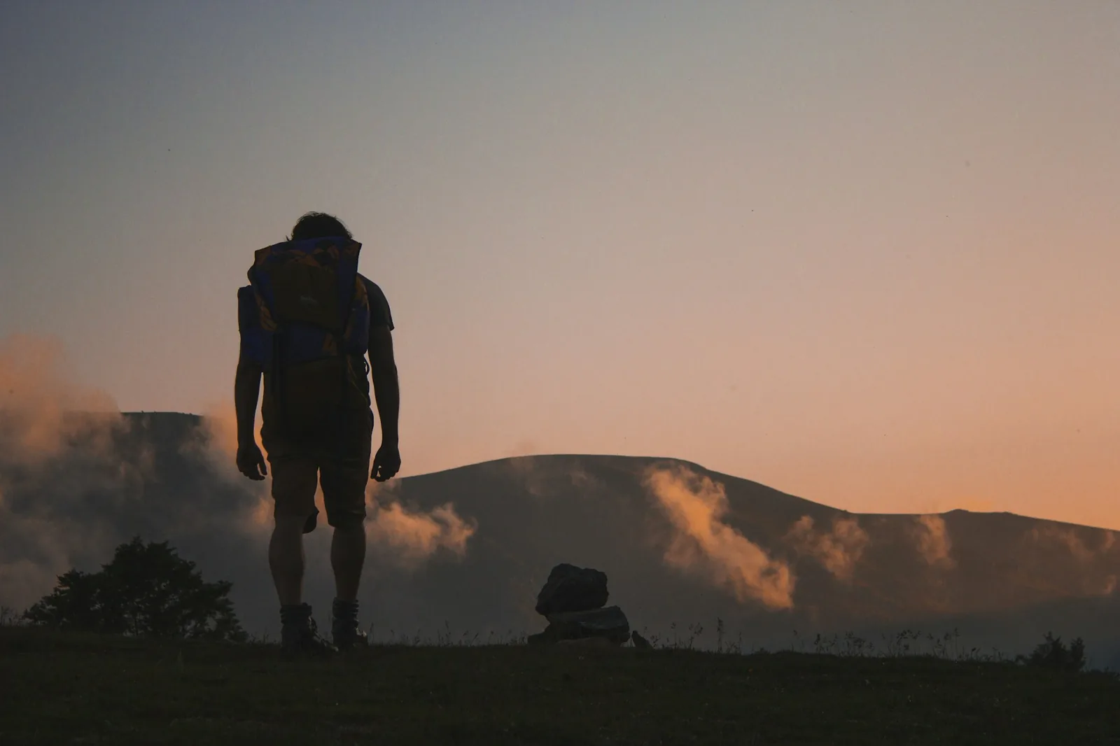 A person walking a quiet path at dusk