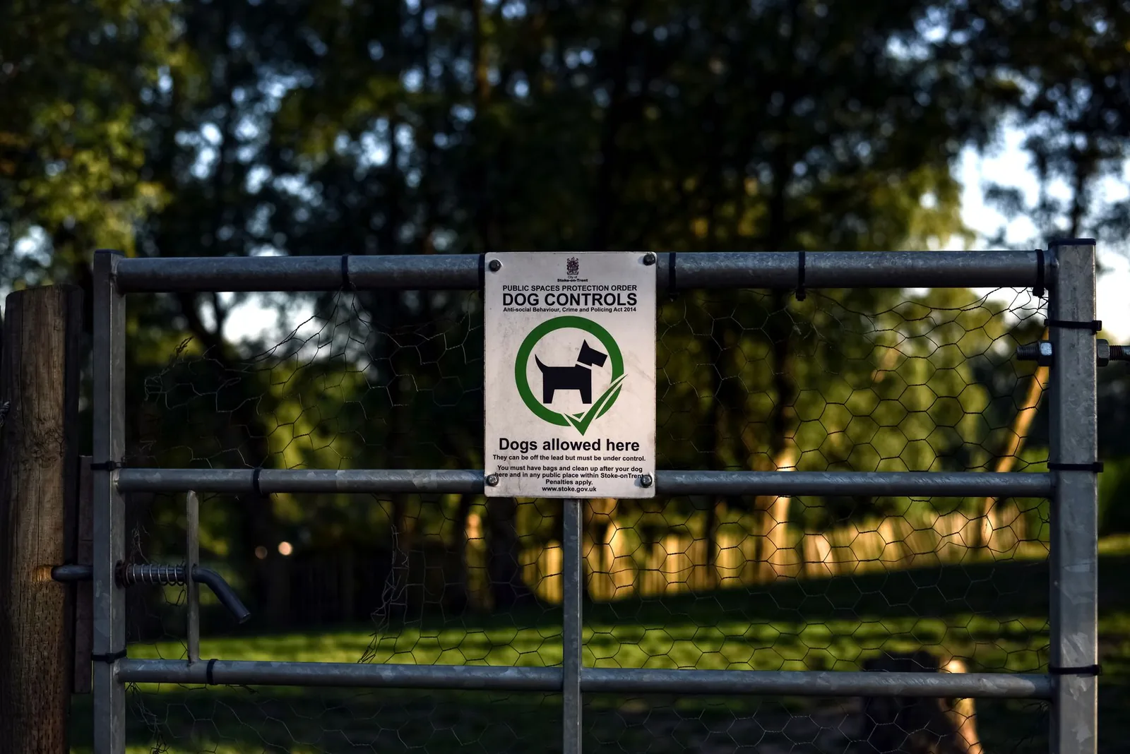 The fenced entrance gate to a dog park