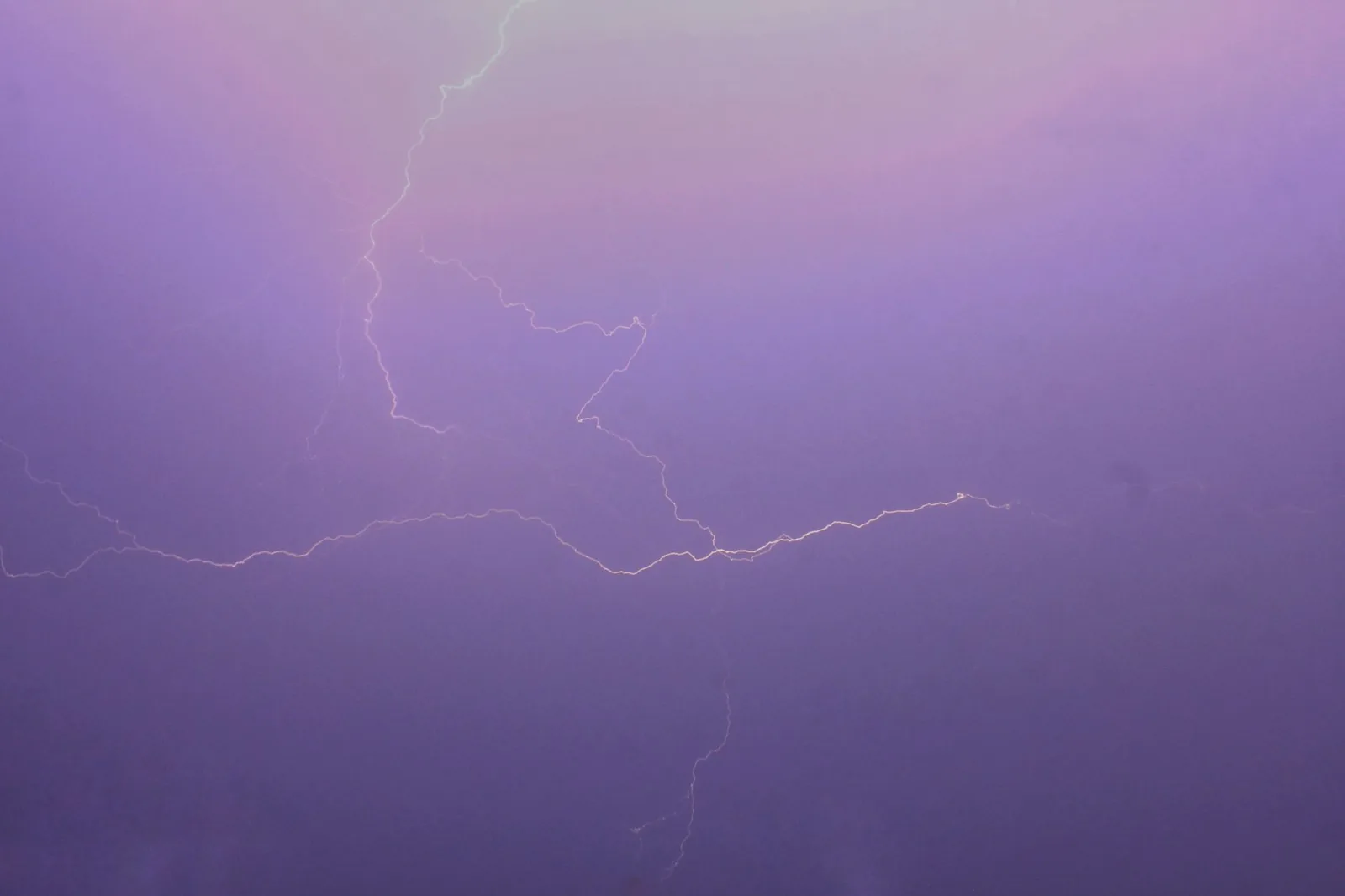 A thunderstorm building over rooftops