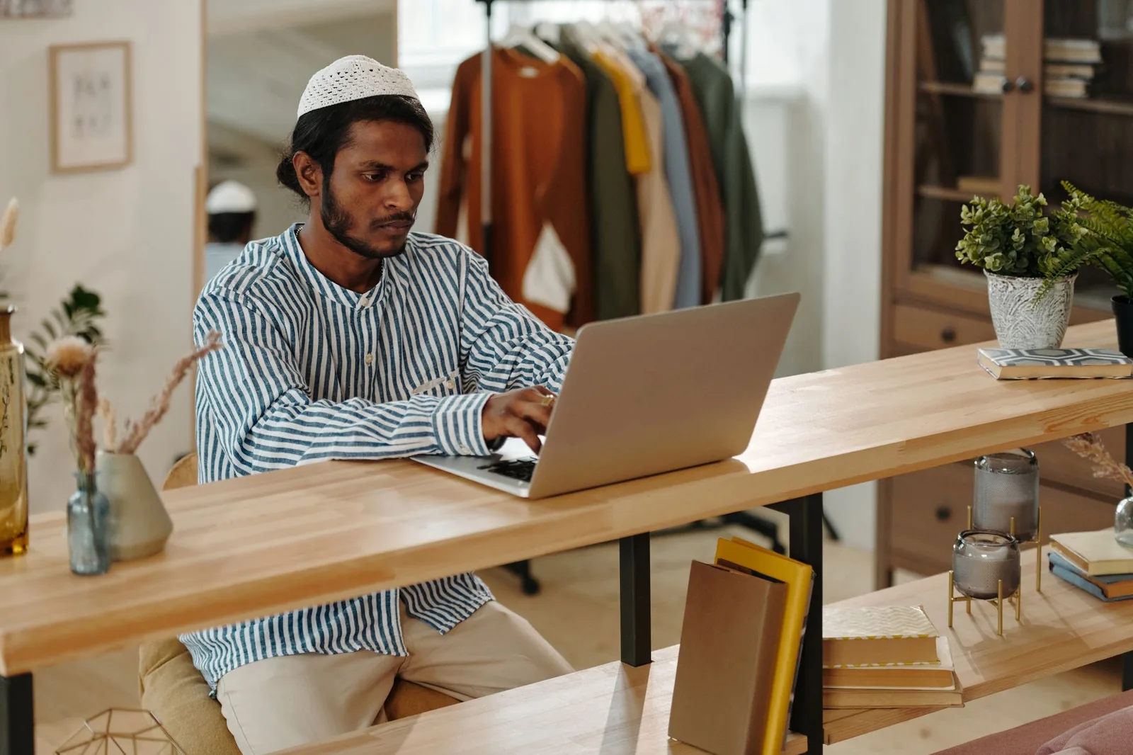 A person updating records on a laptop at home