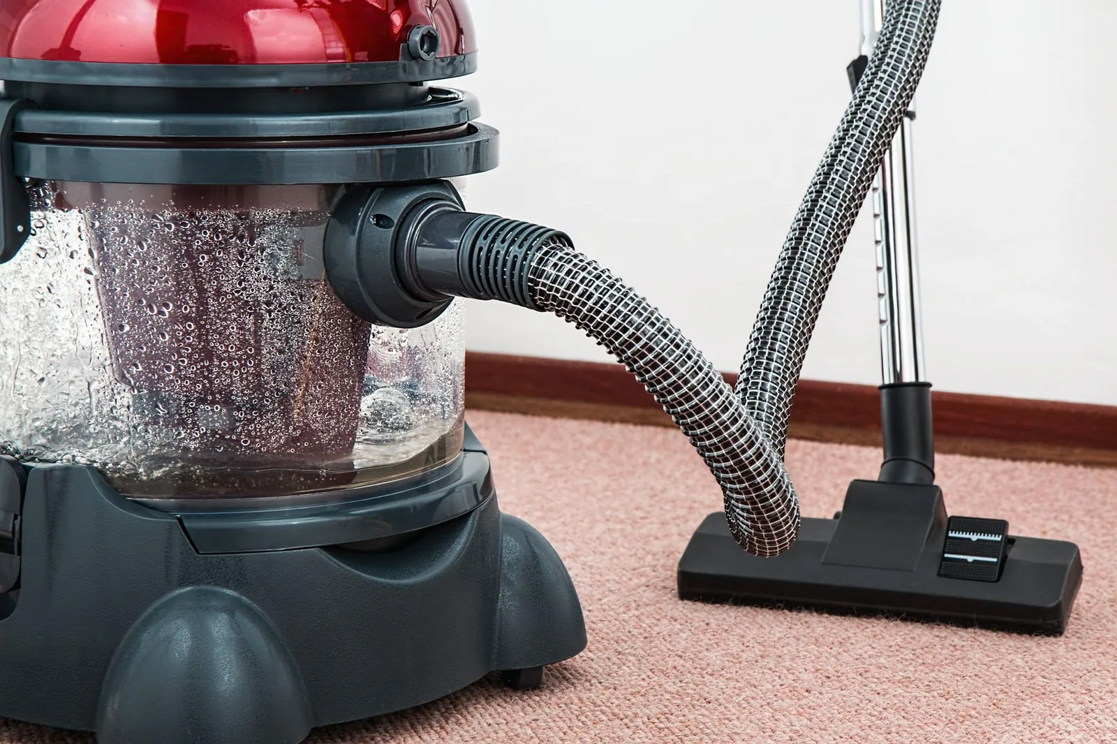 A vacuum cleaner being used on a carpet