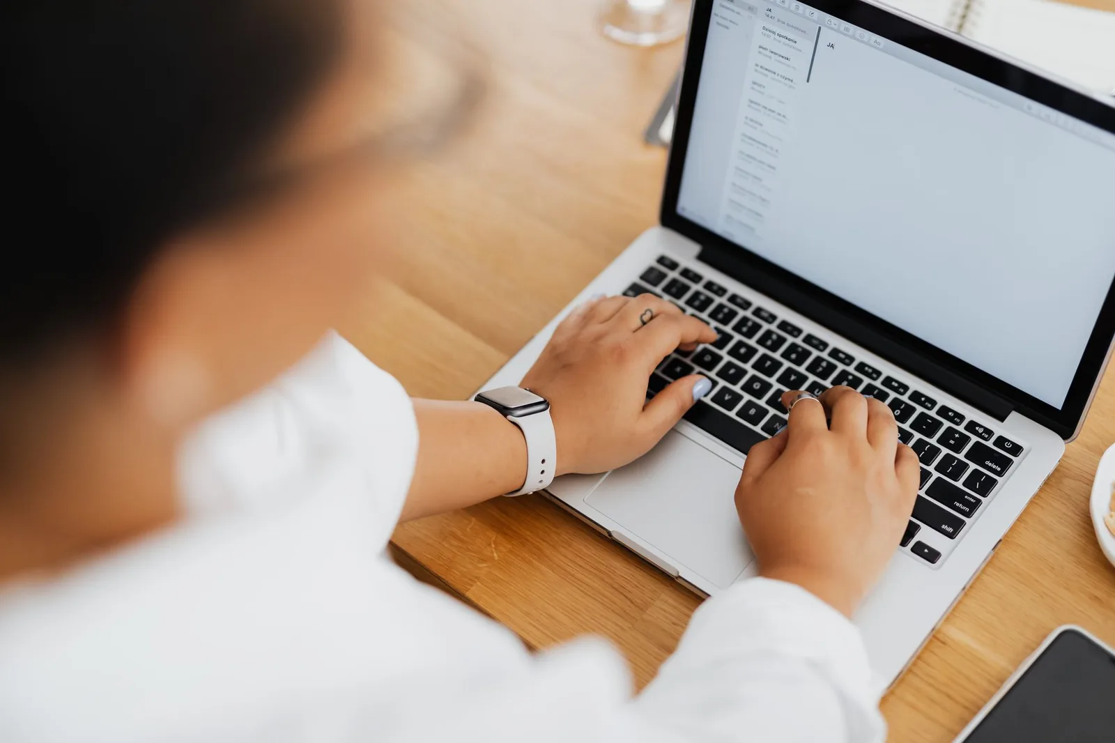 A person writing an email at a laptop